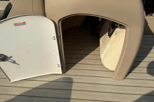Slide: The Image of 2017 Manitou 22 Oasis Standard boat storage compartment with open hatch on deck. - 19