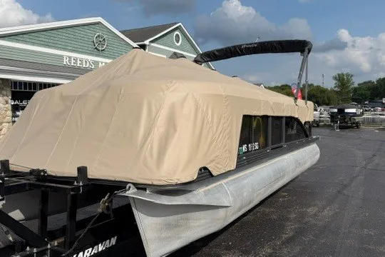 Slide: The Image of 2017 Manitou 22 Oasis Standard pontoon boat with beige cover in parking lot. - 39