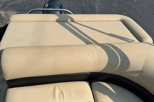 Slide: The Image of 2017 Manitou 22 Oasis Standard boat with beige seating and sleek design. - 34