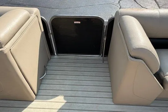 Slide: The Image of 2017 Manitou 22 Oasis Standard boat interior with beige seating and flooring. - 27