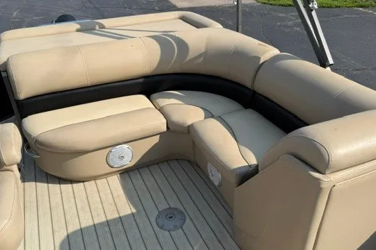 Slide: The Image of 2017 Manitou 22 Oasis Standard boat interior with beige seating and wood flooring. - 30