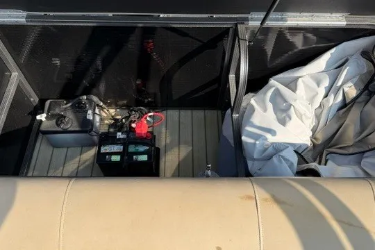 Slide: The Image of 2017 Manitou 22 Oasis Standard boat storage with battery and cover. - 35