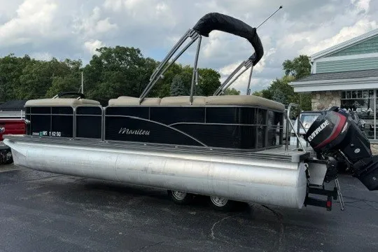 Slide: The Image of 2017 Manitou 22 Oasis Standard pontoon boat with Evinrude motor on trailer. - 3