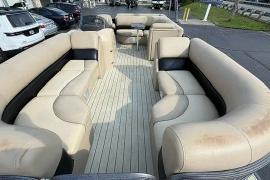Slide: The Image of 2017 Manitou 22 Oasis Standard pontoon boat with spacious seating and beige upholstery. - 24
