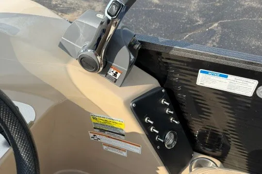 Slide: The Image of Control panel of a 2017 Manitou 22 Oasis Standard boat with throttle and switches. - 16