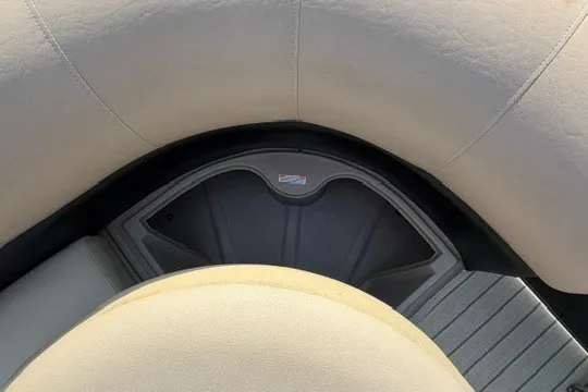 Slide: The Image of 2017 Manitou 22 Oasis Standard boat interior seating with storage compartment. - 25