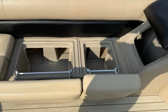 Slide: The Image of 2017 Manitou 22 Oasis Standard boat storage compartments with beige seating. - 20