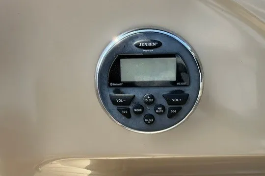 Slide: The Image of Jensen stereo system on 2017 Manitou 22 Oasis Standard boat dashboard. - 14
