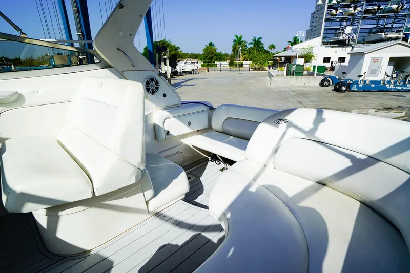Slide: The Image of Luxurious interior of 2004 Regal Commodore 2860 boat with white seating and marina view. - 12
