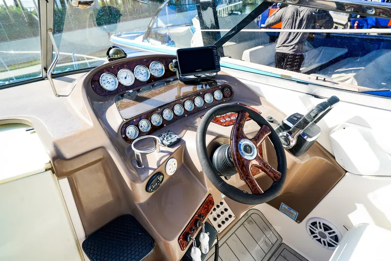 Slide: The Image of Cockpit of 2004 Regal Commodore 2860 boat with steering wheel and instrument panel. - 14