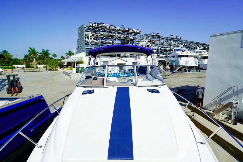 Slide: The Image of 2004 Regal Commodore 2860 boat docked at marina with storage racks in background. - 26