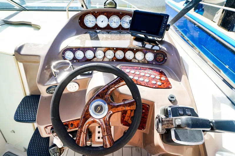 Slide: The Image of Steering console of 2004 Regal Commodore 2860 boat with gauges and controls. - 15