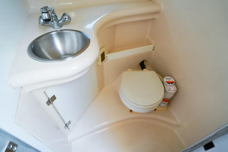 Slide: The Image of Compact bathroom in 2004 Regal Commodore 2860 boat with sink and toilet. - 21