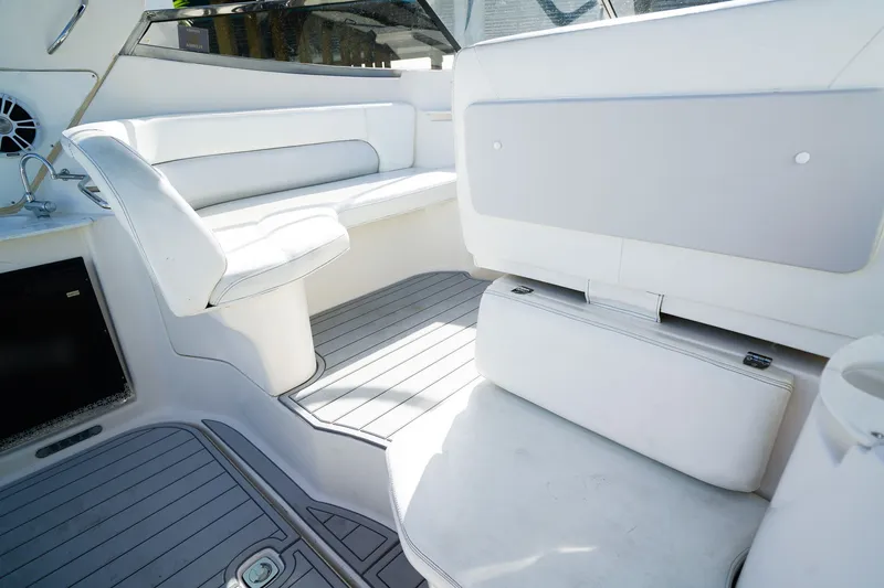 Slide: The Image of 2004 Regal Commodore 2860 boat interior with white seating and sleek design. - 8