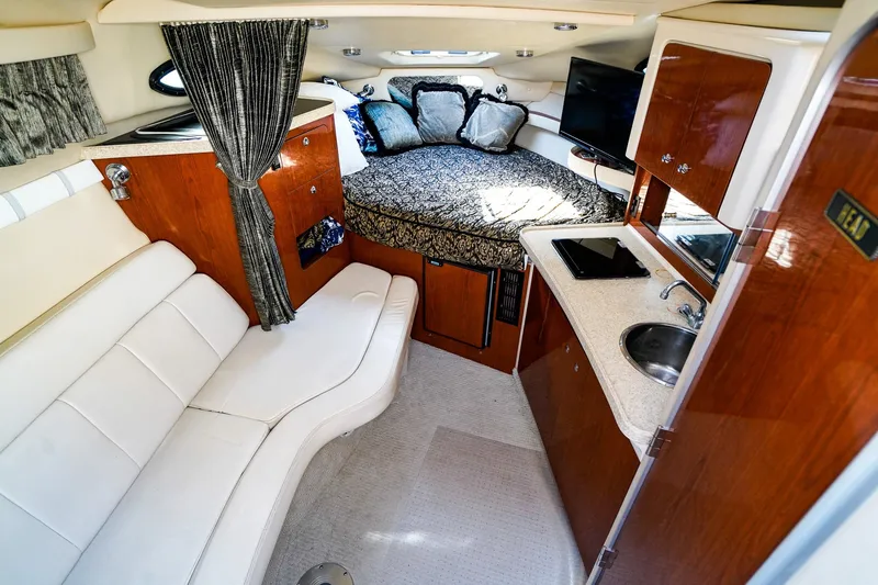 Slide: The Image of Luxurious interior of a 2004 Regal Commodore 2860 yacht with cozy seating and kitchenette. - 16