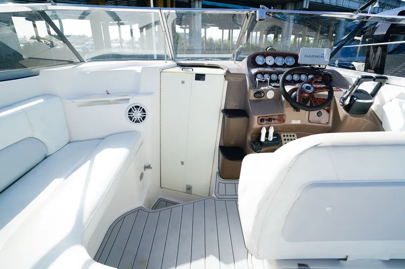 Slide: The Image of 2004 Regal Commodore 2860 boat interior with steering wheel and seating area. - 10