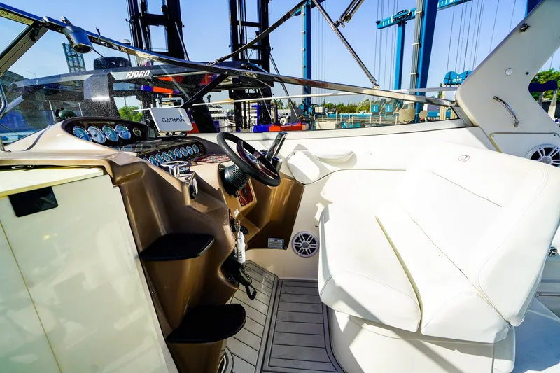 Slide: The Image of Interior view of 2004 Regal Commodore 2860 boat cockpit with steering wheel and controls. - 13