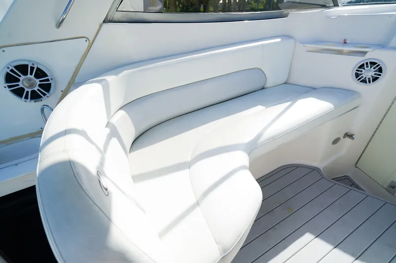 Slide: The Image of White seating area on 2004 Regal Commodore 2860 boat, featuring built-in speakers. - 9