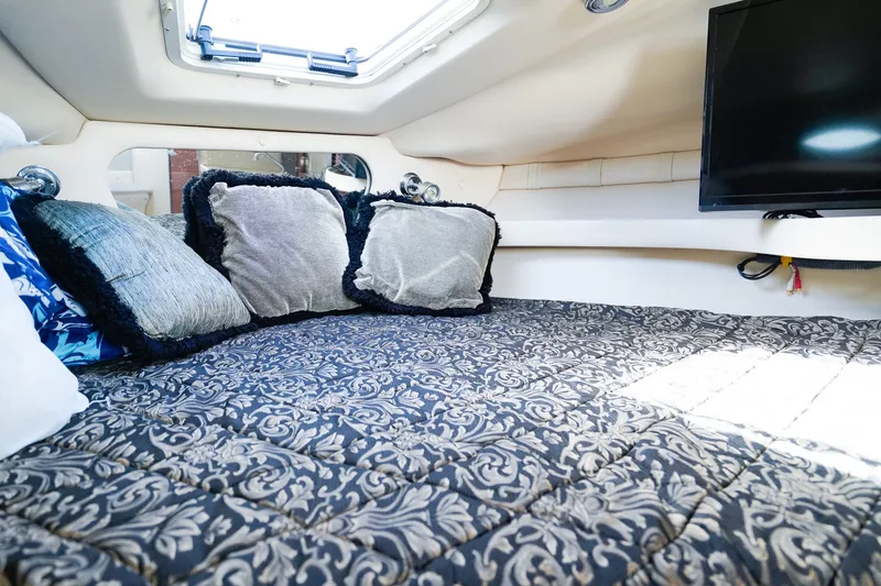 Slide: The Image of Luxurious cabin interior of 2004 Regal Commodore 2860 with plush bedding and pillows. - 20