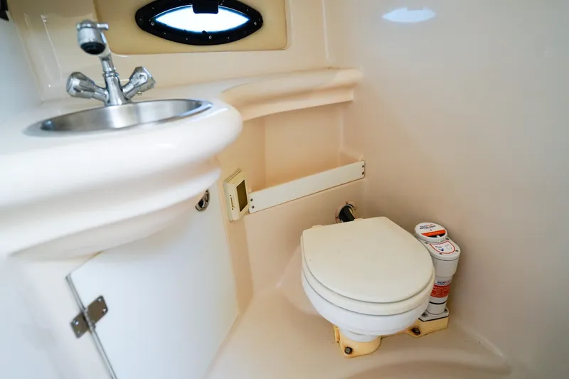 Slide: The Image of Compact bathroom in 2004 Regal Commodore 2860 boat with sink and toilet. - 22