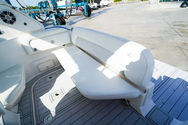 Slide: The Image of 2004 Regal Commodore 2860 boat interior with white seating and deck details. - 6