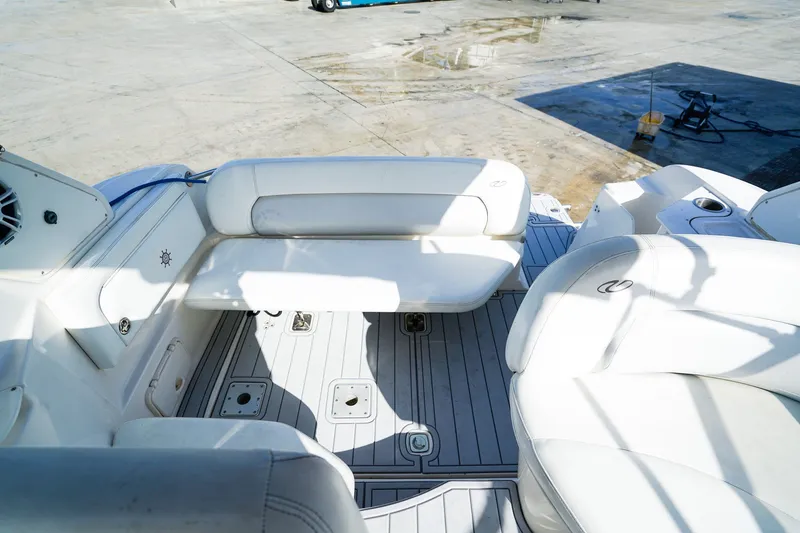 Slide: The Image of 2004 Regal Commodore 2860 boat interior with white seating and deck. - 11