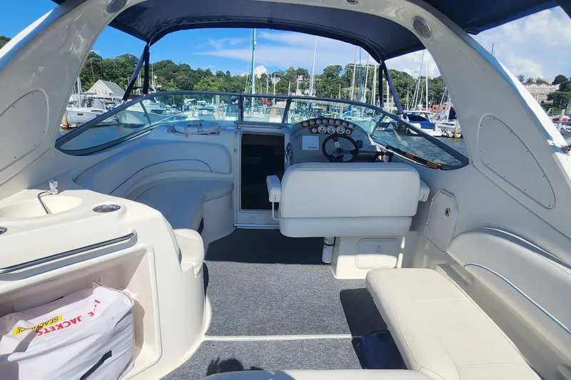 Slide: The Image of Interior view of a 2008 Bayliner 300 boat, featuring seating and steering area. - 6
