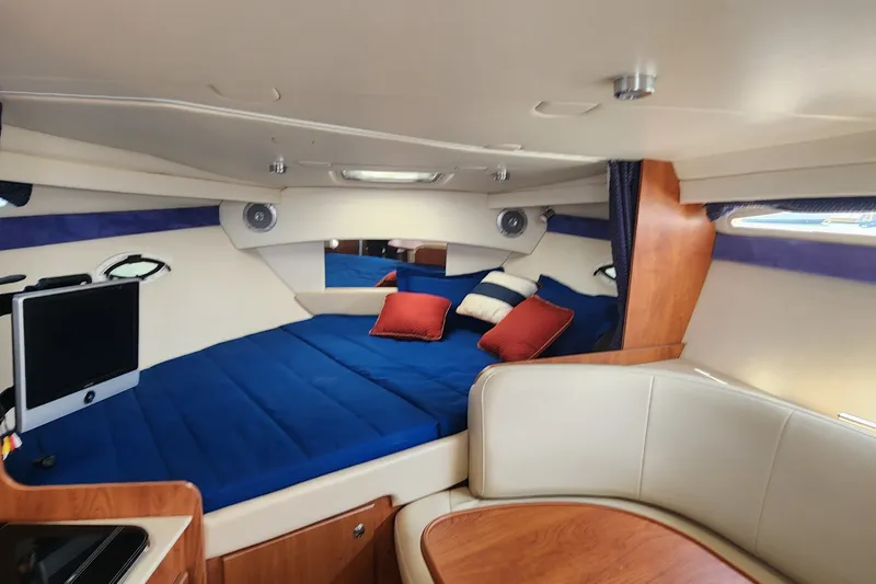 Slide: The Image of Interior of 2008 Bayliner 300 boat with cozy cabin, bed, and TV. - 10