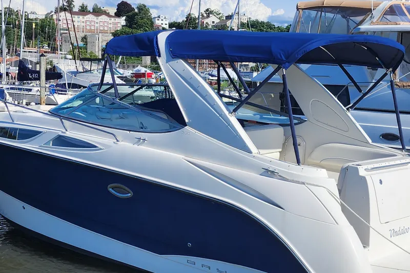 Slide: The Image of 2008 Bayliner 300 boat docked at marina with blue canopy. - 1