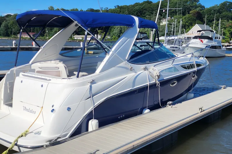 Slide: The Image of 2008 Bayliner 300 boat docked at marina with blue canopy. - 3