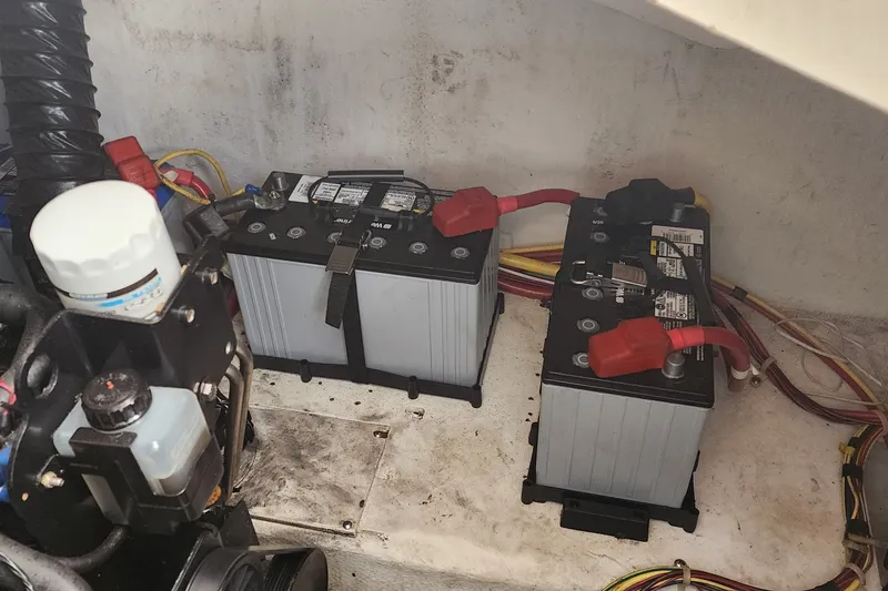 Slide: The Image of 2008 Bayliner 300 boat engine compartment with dual batteries and wiring. - 18