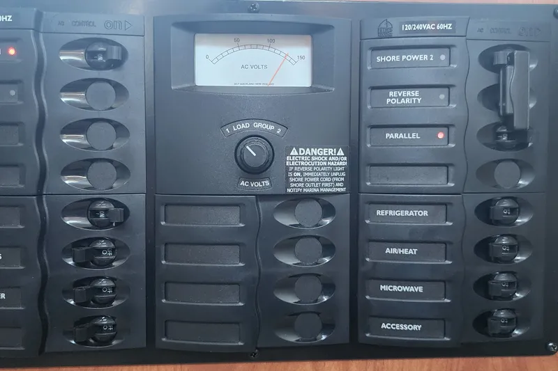 Slide: The Image of Electrical control panel on a 2008 Bayliner 300 boat, featuring AC voltmeter and switches. - 14