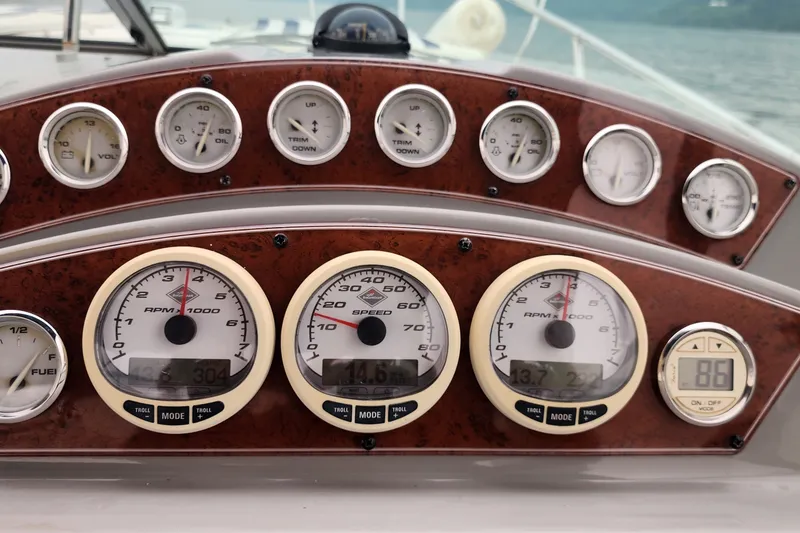 Slide: The Image of Dashboard of a 2008 Bayliner 300 boat with various gauges and controls. - 8
