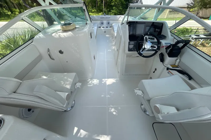Slide: The Image of 2024 World Cat 230 SD boat interior with modern helm and seating arrangement. - 10