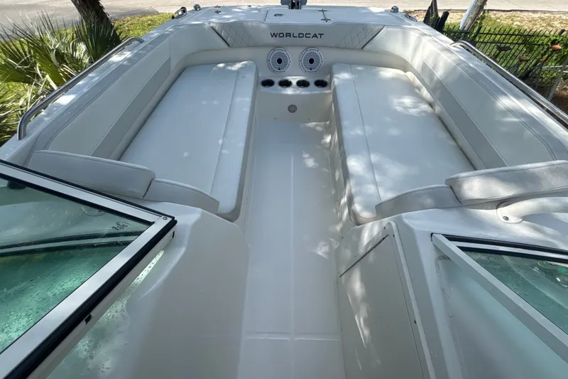 Slide: The Image of 2024 World Cat 230 SD boat interior with white seating and open windshield. - 12