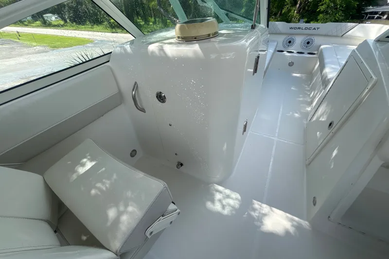 Slide: The Image of Interior of 2024 World Cat 230 SD boat, featuring sleek white seating and modern design. - 17