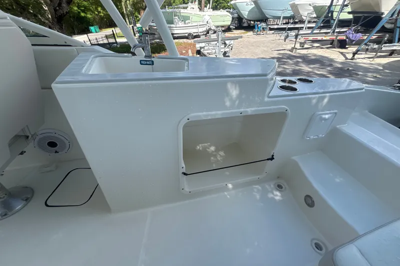 Slide: The Image of 2024 World Cat 230 SD boat interior with sink and storage compartment. - 9