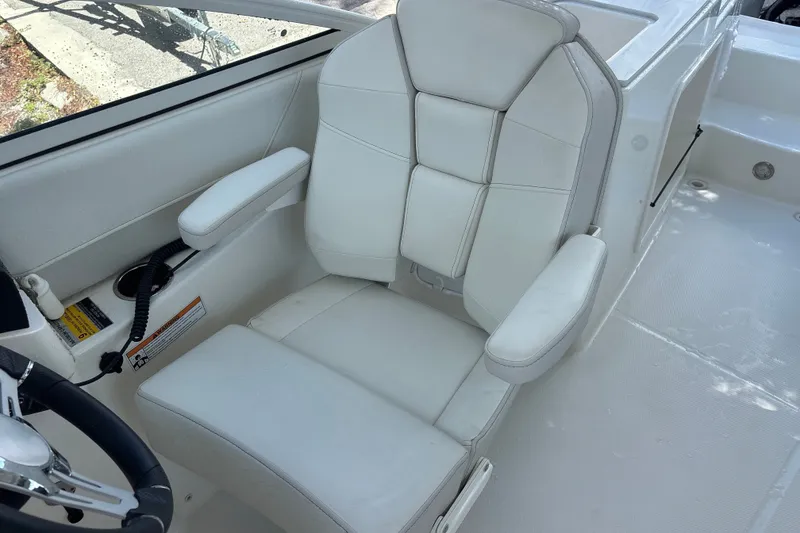 Slide: The Image of Luxurious white seating in 2024 World Cat 230 SD boat interior. - 15