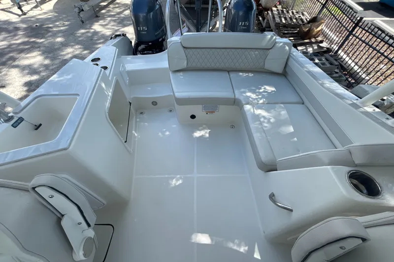 Slide: The Image of 2024 World Cat 230 SD boat interior with spacious seating and dual 115 engines. - 7