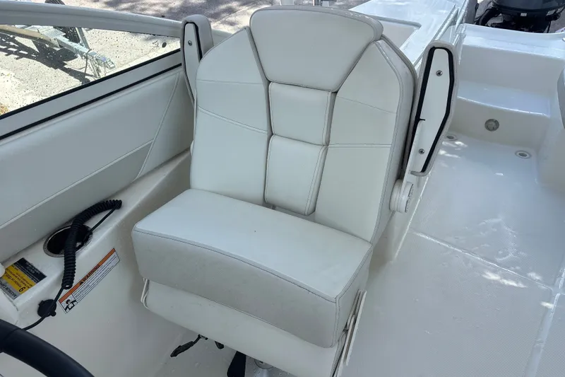 Slide: The Image of White captain's chair on 2024 World Cat 230 SD boat deck. - 13