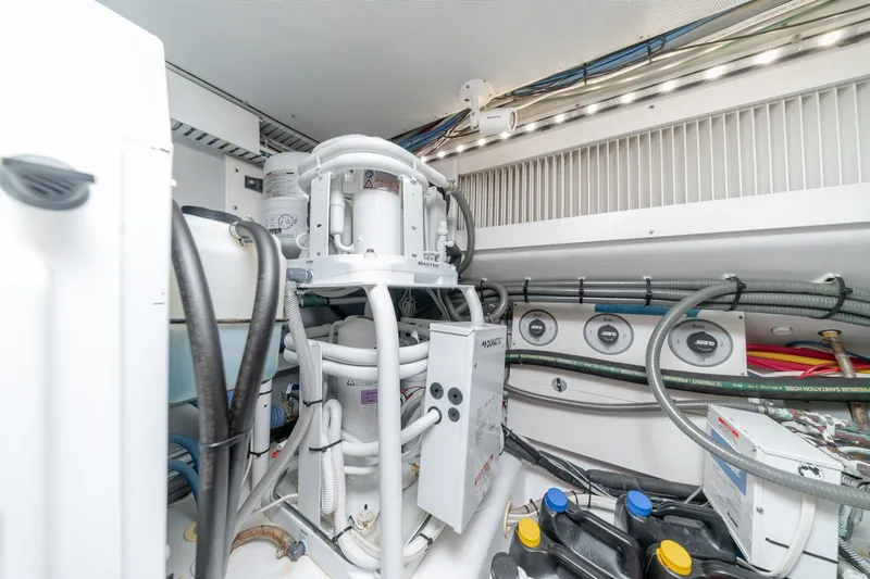 Slide: The Image of Engine room of a 2010 Jamie Chadwick 61' Convertible yacht, showcasing mechanical components. - 46