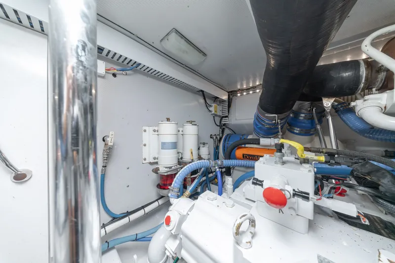 Slide: The Image of Engine room of a 2010 Jamie Chadwick 61' Convertible yacht, showcasing mechanical components. - 51