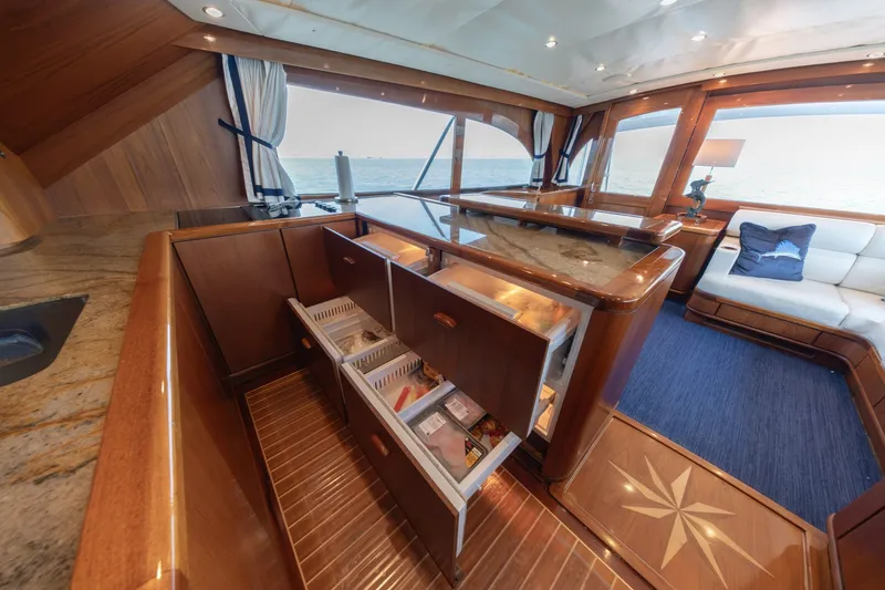 Slide: The Image of Luxurious interior of a 2010 Jamie Chadwick 61' Convertible yacht with elegant wood finishes. - 77