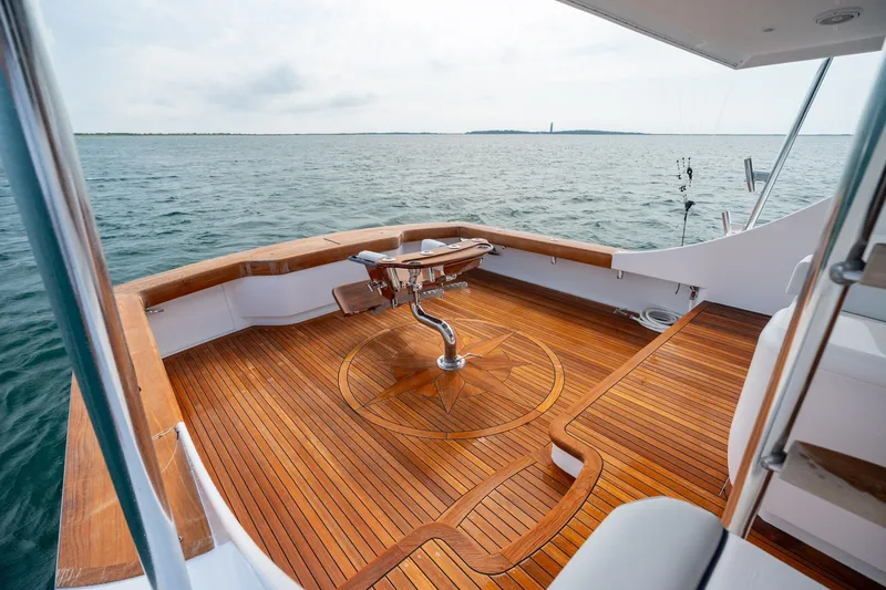 Slide: The Image of Luxurious 2010 Jamie Chadwick 61' Convertible yacht with elegant wooden deck on open water. - 19