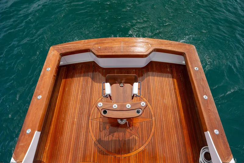 Slide: The Image of Luxurious 2010 Jamie Chadwick 61' Convertible yacht deck with polished wood finish. - 70