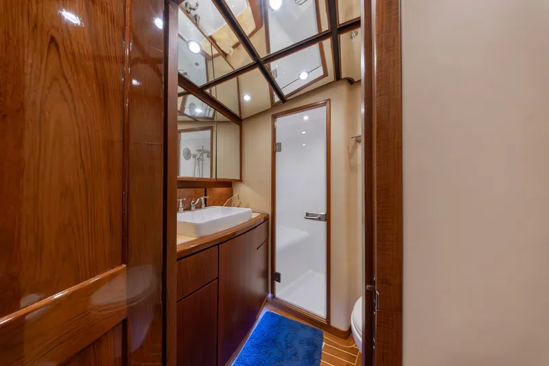 Slide: The Image of Luxurious bathroom in 2010 Jamie Chadwick 61' Convertible yacht with wood accents and modern fixtures. - 95
