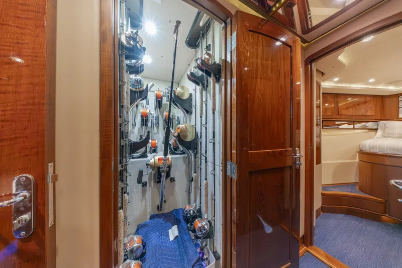 Slide: The Image of Luxurious yacht interior with fishing rod storage, wooden finishes, and cozy bedroom. Jamie Chadwick 61' Convertible. - 88