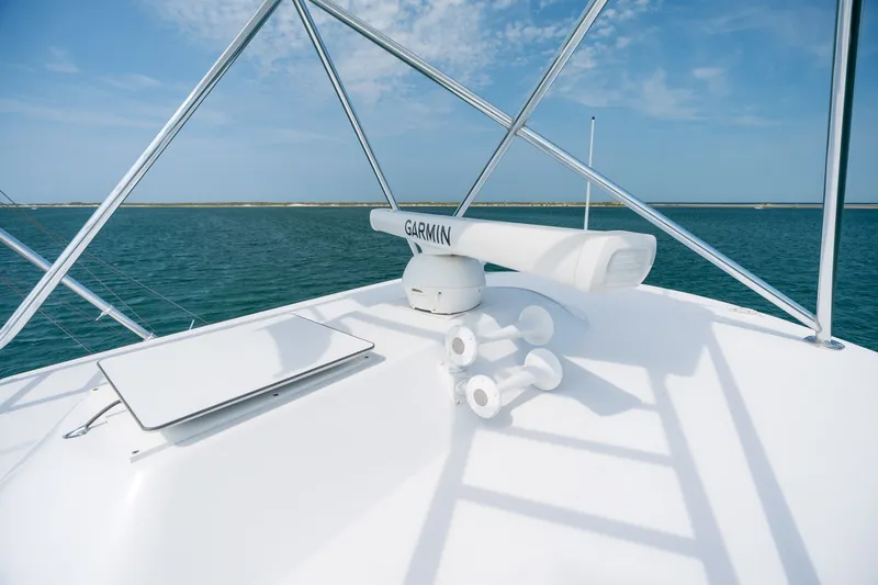 Slide: The Image of Rooftop view of 2010 Jamie Chadwick 61' Convertible yacht with Garmin radar, ocean backdrop. - 65