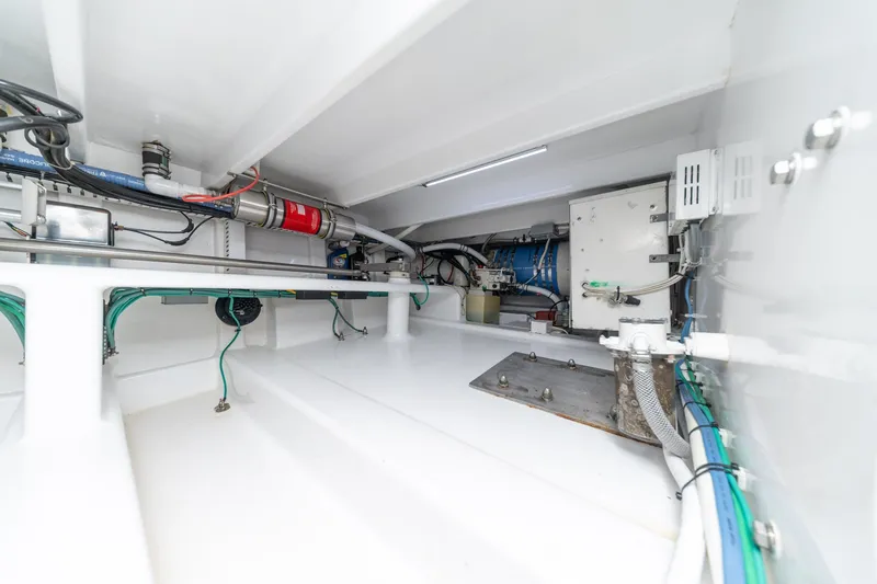 Slide: The Image of Engine room of a 2010 Jamie Chadwick 61' Convertible yacht, showcasing mechanical components. - 55