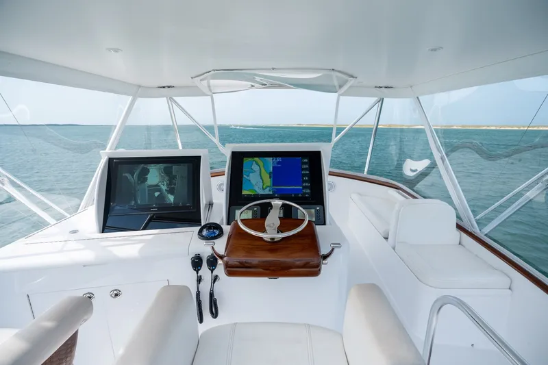 Slide: The Image of Helm of 2010 Jamie Chadwick 61' Convertible yacht with navigation screens and ocean view. - 56